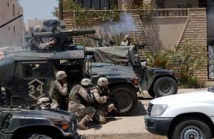 Soldiers of the Army's 101st Airborne Division (Air Assault) fire a TOW missile at a building suspected of harboring Saddam Hussein's sons Qusay and Uday in Mosul, Iraq, on July 22, 2003. 