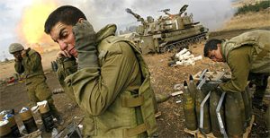 sraeli soldiers cover their ears as an artillery unit fires shells towards southern Lebanon. Image: AP